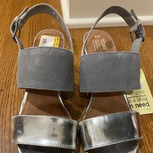 Tom’s sandle, new with tags.  Never worn.  Silver metallic with grey suede.